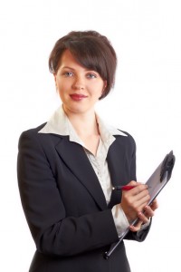 woman taking notes on clipboard