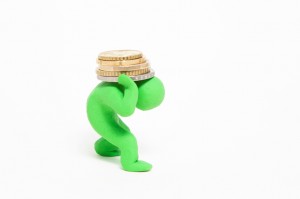 small green plasticine puppet bears stack of coins