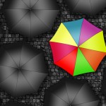 Many colors umbrella. Bright umbrella among set of black umbrell